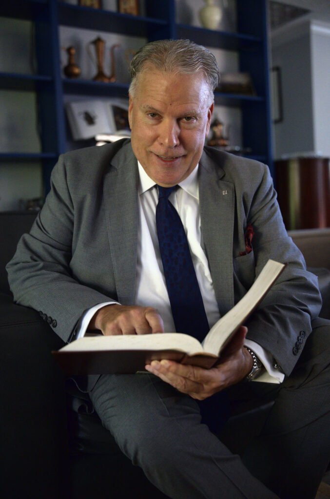 Corporate headshot of an attorney in a law library
